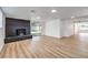 Spacious living room features a fireplace, wood-look floors, and ample natural light from sliding glass doors at 6308 Lawton Ave, Las Vegas, NV 89107