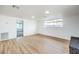 Neutral living room features wood-look floors, white paint, and bright natural light throughout at 6308 Lawton Ave, Las Vegas, NV 89107
