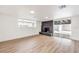 Spacious living room has wood-look floors, fireplace, sliding glass doors and a large window for natural light at 6308 Lawton Ave, Las Vegas, NV 89107