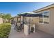 Serene outdoor dining area with a built-in bar under a shaded patio, perfect for entertaining at 7030 Silver Ridge Peak St, Las Vegas, NV 89166