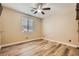 Neutral bedroom with hardwood floors, a ceiling fan, and a window with blinds at 7030 Silver Ridge Peak St, Las Vegas, NV 89166