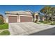 Well-maintained house showcasing a three-car garage, tiled roof and neat landscaping at 7030 Silver Ridge Peak St, Las Vegas, NV 89166