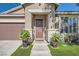 Front entrance with meticulously maintained lawn, potted plants, and a charming covered porch at 7030 Silver Ridge Peak St, Las Vegas, NV 89166