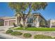 Charming single-story home with a well-manicured front yard, stone accents, and mature landscaping at 7030 Silver Ridge Peak St, Las Vegas, NV 89166