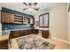 Spacious home office with custom built-in shelving, desk space, and a window with plantation shutters at 7030 Silver Ridge Peak St, Las Vegas, NV 89166
