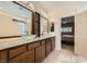 Beautiful main bathroom with double sinks, tile flooring, and a view of the bedroom at 7030 Silver Ridge Peak St, Las Vegas, NV 89166