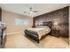 Relaxing main bedroom with a brick accent wall, ceiling fan, and plantation shutters at 7030 Silver Ridge Peak St, Las Vegas, NV 89166