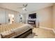 Comfortable main bedroom featuring a fireplace, TV, and doorway access to the en-suite bath and walk-in closet at 7030 Silver Ridge Peak St, Las Vegas, NV 89166