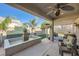Charming covered patio offering a relaxing retreat with a water feature and comfortable seating at 7030 Silver Ridge Peak St, Las Vegas, NV 89166