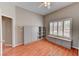 Bedroom featuring a large window with shutters, built-in shelving, and wood-look flooring at 7540 Crystal Cave Dr, Las Vegas, NV 89117