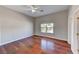 Bright bedroom featuring hardwood floors, a ceiling fan, and a window with views of the landscape at 7540 Crystal Cave Dr, Las Vegas, NV 89117