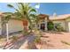 Inviting home entrance featuring a brick walkway, desert landscaping and palm tree at 7540 Crystal Cave Dr, Las Vegas, NV 89117