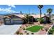 Lovely single-story home boasting a three-car garage, desert landscaping, and a well-manicured yard at 7540 Crystal Cave Dr, Las Vegas, NV 89117