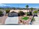 Well-maintained single-story home showcasing desert landscaping, a long driveway and a three-car garage at 7540 Crystal Cave Dr, Las Vegas, NV 89117