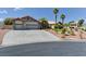 Charming single-story home featuring a three-car garage, desert landscaping and a curved concrete driveway at 7540 Crystal Cave Dr, Las Vegas, NV 89117