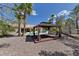 Backyard view of a gazebo on brick platform with view of the pool and landscaping at 7540 Crystal Cave Dr, Las Vegas, NV 89117