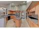 Bright kitchen featuring an island, stainless steel appliances, granite countertops, and light wood cabinets at 7540 Crystal Cave Dr, Las Vegas, NV 89117