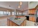 Open kitchen concept featuring an island with a sink, breakfast bar, and stainless steel appliances at 7540 Crystal Cave Dr, Las Vegas, NV 89117