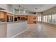 Open kitchen features tile floor, breakfast bar, bright cabinets, and backyard access at 7540 Crystal Cave Dr, Las Vegas, NV 89117