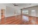 Spacious living room featuring hardwood floors, ceiling fans, and natural light at 7540 Crystal Cave Dr, Las Vegas, NV 89117