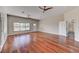 Large living room featuring hardwood floors, ceiling fans, and view of backyard pool at 7540 Crystal Cave Dr, Las Vegas, NV 89117