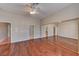 Primary bedroom with hardwood floors, a ceiling fan, and large mirrored closet doors at 7540 Crystal Cave Dr, Las Vegas, NV 89117
