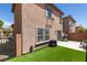 The backyard features artificial grass and a sliding glass door at 8733 Autumn Teal Ave, Las Vegas, NV 89178