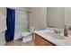 Bright bathroom featuring a marble countertop and shower with a blue shower curtain at 8733 Autumn Teal Ave, Las Vegas, NV 89178