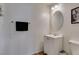 Clean, well-lit bathroom with a white vanity, oval mirror, and towel bar at 8733 Autumn Teal Ave, Las Vegas, NV 89178
