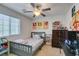 Bright bedroom featuring light gray walls, a window, and a collection of anime-themed decorations at 8733 Autumn Teal Ave, Las Vegas, NV 89178