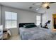 This simple bedroom features a modern ceiling fan, a dresser, and a stationary bicycle at 8733 Autumn Teal Ave, Las Vegas, NV 89178