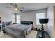 This cozy bedroom includes neutral carpet, a modern fan, and a stationary bicycle at 8733 Autumn Teal Ave, Las Vegas, NV 89178