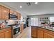 Stylish kitchen with wooden cabinets, granite countertops, stainless steel appliances, and sliding glass door access at 8733 Autumn Teal Ave, Las Vegas, NV 89178
