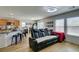 Open floorplan showcasing living area with a comfortable leather couch and adjacent eat-in kitchen at 8733 Autumn Teal Ave, Las Vegas, NV 89178