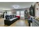 Spacious living room with recessed lighting, wood flooring, and a comfortable black leather sofa at 8733 Autumn Teal Ave, Las Vegas, NV 89178