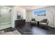 The room features sleek dark wood floors, with accent chairs and a picturesque view from a large window at 934 Lewis Ct, Henderson, NV 89015