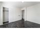 A simple bedroom with closet and door leading to other rooms featuring clean lines and dark wood floors at 934 Lewis Ct, Henderson, NV 89015