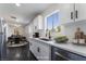 Modern kitchen with white cabinets, sleek countertops, and stainless steel appliances at 934 Lewis Ct, Henderson, NV 89015