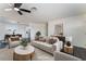 Inviting living area with stylish furniture, dark floors, and access to dining room at 934 Lewis Ct, Henderson, NV 89015