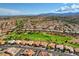 Expansive aerial view of a golf course community with lush green fairways and red-tiled roofs at 9512 Quail Ridge Dr, Las Vegas, NV 89134