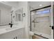 Bright bathroom with a glass-enclosed shower featuring a window and tile surround at 9512 Quail Ridge Dr, Las Vegas, NV 89134