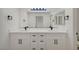 Modern bathroom featuring a dual sink vanity with white countertops and black hardware at 9512 Quail Ridge Dr, Las Vegas, NV 89134