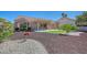 Single-story home featuring manicured landscaping, desert accents, and a tile roof at 9512 Quail Ridge Dr, Las Vegas, NV 89134