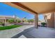Covered patio featuring landscaped backyard with plants and an artificial lawn at 9512 Quail Ridge Dr, Las Vegas, NV 89134