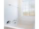 Bright white bathroom featuring a soaking tub with chrome fixtures and a frosted window at 965 Nevada State Dr # 15104, Henderson, NV 89002