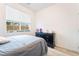 Bedroom featuring a bed with a gray comforter, a window, and light wood-look floors at 965 Nevada State Dr # 15104, Henderson, NV 89002