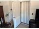 View of a white door opening to reveal an accordion style door with a floral arrangement nearby at 965 Nevada State Dr # 15104, Henderson, NV 89002