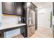 Modern kitchen featuring stainless steel refrigerator, black cabinetry, and white countertops at 965 Nevada State Dr # 15104, Henderson, NV 89002