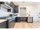 Modern kitchen featuring stainless steel appliances, black cabinetry, white countertops, and a window at 965 Nevada State Dr # 15104, Henderson, NV 89002