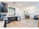 Open kitchen featuring stainless steel appliances, black cabinetry, and light wood-look flooring at 965 Nevada State Dr # 15104, Henderson, NV 89002